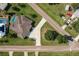 Detailed aerial view of home with long driveway, lush lawn, and screened in pool at 437 South Dr, Punta Gorda, FL 33950