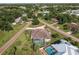Expansive aerial view displaying the property, its lush surroundings, and nearby lake at 437 South Dr, Punta Gorda, FL 33950