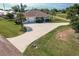 Charming single-story home featuring a long driveway, attached garage, and well-kept lawn at 437 South Dr, Punta Gorda, FL 33950