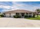 Beautiful residence showcasing a well-maintained lawn, attached garage, and welcoming porch at 437 South Dr, Punta Gorda, FL 33950