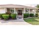 Charming front porch with decorative columns, lush landscaping, and a welcoming entrance at 437 South Dr, Punta Gorda, FL 33950