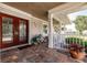 Charming front porch with decorative glass doors and cozy seating area at 437 South Dr, Punta Gorda, FL 33950