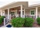 Charming front porch with seating, lovely landscaping, and decorative details, offering a welcoming entrance at 437 South Dr, Punta Gorda, FL 33950