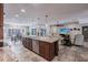 Open-concept kitchen showcasing a large island with sink, and seamless flow into the living and dining areas at 437 South Dr, Punta Gorda, FL 33950