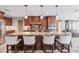 Gourmet kitchen featuring a large island with barstool seating, granite countertops, and custom cabinetry at 437 South Dr, Punta Gorda, FL 33950