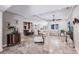 Spacious living area showcasing travertine floors, a ceiling fan, and an open layout to the gourmet kitchen at 437 South Dr, Punta Gorda, FL 33950