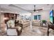 Large living area with travertine floors, ceiling fan, opening to the gourmet kitchen, perfect for entertaining at 437 South Dr, Punta Gorda, FL 33950