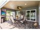 Outdoor patio space, offering shade, ceiling fan, a table for six and a flatscreen TV at 437 South Dr, Punta Gorda, FL 33950