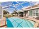 Screened-in pool with inviting lounge chairs and seamless access to the outdoor dining area at 437 South Dr, Punta Gorda, FL 33950