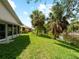 Enjoy the beautiful water views from the expansive backyard with mature palm trees at 464 Rose Apple Cir, Port Charlotte, FL 33954