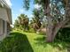 Expansive backyard features mature trees with water view, perfect for relaxation at 464 Rose Apple Cir, Port Charlotte, FL 33954