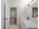 Bathroom view with vanity, quartz countertop, and view into bedroom at 464 Rose Apple Cir, Port Charlotte, FL 33954