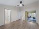Bedroom with ceiling fan, slider doors to screened in porch, and connecting rooms at 464 Rose Apple Cir, Port Charlotte, FL 33954
