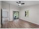 Bedroom with ceiling fan, slider doors to screen patio, and a window at 464 Rose Apple Cir, Port Charlotte, FL 33954
