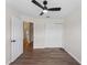 Cozy bedroom with hard surface floors, ceiling fan, closet, and doorway to hall at 464 Rose Apple Cir, Port Charlotte, FL 33954