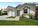 Stucco home with blue trim detail around the window and entrance, next to the garage at 464 Rose Apple Cir, Port Charlotte, FL 33954
