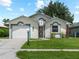 Charming single-story home with a well-manicured lawn and a white front door at 464 Rose Apple Cir, Port Charlotte, FL 33954