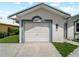 Image of the garage entrance showing the white door with blue trim accents at 464 Rose Apple Cir, Port Charlotte, FL 33954