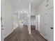 Spacious hallway with wood-look floors leading to other rooms in the house at 464 Rose Apple Cir, Port Charlotte, FL 33954