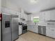 Spacious kitchen boasts stainless steel appliances, tile flooring and plenty of natural light at 464 Rose Apple Cir, Port Charlotte, FL 33954