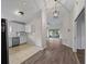 Open-concept kitchen with white cabinets and stainless steel appliances adjacent to living area at 464 Rose Apple Cir, Port Charlotte, FL 33954