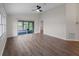 Large living room with hardwood floors, ceiling fan, and screened-in porch at 464 Rose Apple Cir, Port Charlotte, FL 33954