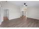 Open living room with hard wood flooring, ceiling fan, and access to hall and front room at 464 Rose Apple Cir, Port Charlotte, FL 33954