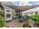 Enjoy outdoor dining on the brick patio with a shade sail, perfect for relaxing or entertaining at 477 Ricold Ter, Port Charlotte, FL 33954