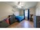 This bedroom features a ceiling fan, a window, and wood-look floors at 477 Ricold Ter, Port Charlotte, FL 33954