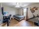 Bedroom with ceiling fan, hardwood floors, and a window for natural light at 477 Ricold Ter, Port Charlotte, FL 33954