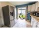 Bright eat-in kitchen features stainless steel appliances and sliding glass doors to the backyard at 477 Ricold Ter, Port Charlotte, FL 33954