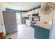 Well-lit kitchen featuring white cabinets, stainless steel appliances, and blue accent wall at 477 Ricold Ter, Port Charlotte, FL 33954