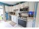 Modern kitchen with stainless steel appliances, white cabinets, and stylish backsplash at 477 Ricold Ter, Port Charlotte, FL 33954