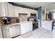 Updated kitchen features white cabinets, stainless steel appliances, and tile backsplash at 477 Ricold Ter, Port Charlotte, FL 33954
