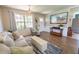 Cozy living room with hardwood floors, comfortable seating, and a mounted flat-screen TV at 477 Ricold Ter, Port Charlotte, FL 33954