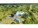 Aerial view of home on sprawling acreage with lush landscaping and a long driveway at 5950 Cypress Grove Cir, Punta Gorda, FL 33982
