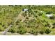 Aerial view of a large property with a long driveway, a home in the distance, surrounded by natural landscape at 5950 Cypress Grove Cir, Punta Gorda, FL 33982