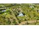 Home with a metal roof, lawn, and wooded area in Prairie Creek Park at 5950 Cypress Grove Cir, Punta Gorda, FL 33982