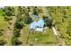 Aerial view showcasing a home with a pool, enclosed backyard, well-maintained lawn and surrounding trees at 5950 Cypress Grove Cir, Punta Gorda, FL 33982