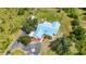 A bright aerial view of a house featuring a backyard pool, a pristine lawn, and a stylish driveway at 5950 Cypress Grove Cir, Punta Gorda, FL 33982