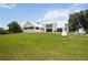 Large backyard with a well-kept lawn, partially fenced, providing lots of space for outdoor activities at 5950 Cypress Grove Cir, Punta Gorda, FL 33982