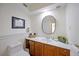 Charming half-bathroom with marble counters, a mirror, and neutral finishes at 5950 Cypress Grove Cir, Punta Gorda, FL 33982