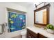 Charming bathroom with a vibrant shower curtain, stylish vanity, and natural light at 5950 Cypress Grove Cir, Punta Gorda, FL 33982