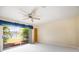 Neutral bedroom featuring a ceiling fan, outdoor views, and a sliding glass door at 5950 Cypress Grove Cir, Punta Gorda, FL 33982