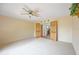 Bedroom with ceiling fan and wood-look doors leading to bathroom at 5950 Cypress Grove Cir, Punta Gorda, FL 33982