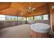 Inviting sunroom with vaulted wood ceilings and a jacuzzi at 5950 Cypress Grove Cir, Punta Gorda, FL 33982