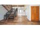Bright foyer with wood floors, staircase, and large windows providing natural light at 5950 Cypress Grove Cir, Punta Gorda, FL 33982