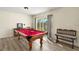 Bright game room featuring a wooden pool table and outdoor views at 5950 Cypress Grove Cir, Punta Gorda, FL 33982