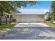 Spacious garage with a white door and an expansive driveway at 5950 Cypress Grove Cir, Punta Gorda, FL 33982