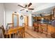 Bright kitchen and dining area showcasing wood cabinets and floors plus an ornate glass door at 5950 Cypress Grove Cir, Punta Gorda, FL 33982